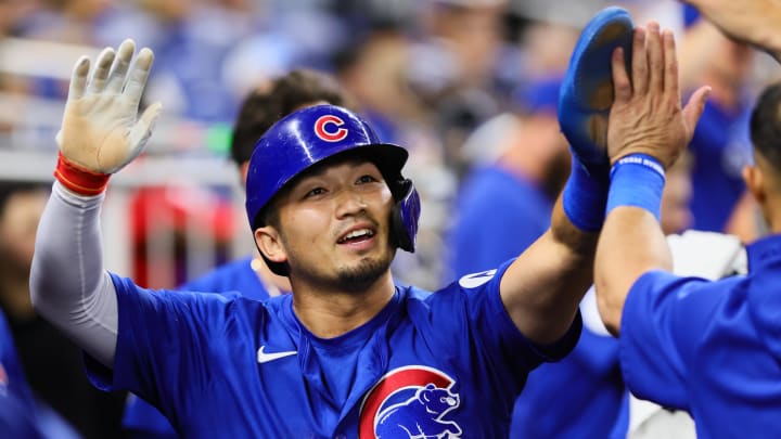 Aug 23, 2024; Miami, Florida, USA; Chicago Cubs designated hitter Seiya Suzuki (27) celebrates with teammates after scoring against the Miami Marlins during the eighth inning at loanDepot Park. 