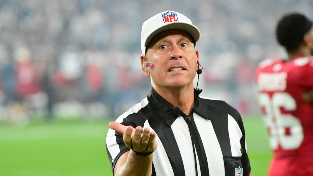 Aug 22, 2026; Glendale, Arizona, USA;  Referee John Hussey practices a coin flip before a game between the Arizona Cardinals and the Dallas Cowboys at State Farm Stadium.  Mandatory Credit: Matt Kartozian-Imagn Images