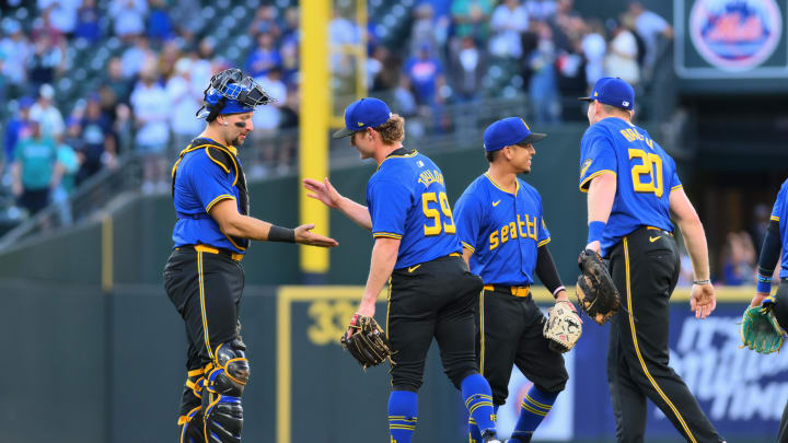 Seattle Mariners catcher Cal Raleigh (29) and relief pitcher Troy Taylor (59) celebrate defeating the New York Mets during the ninth inning at T-Mobile Park on Aug 11.