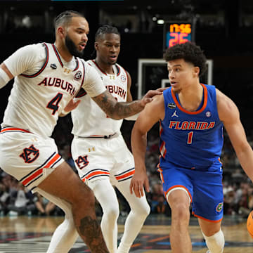 Florida Gators guard Walter Clayton Jr. dribbles the ball against Auburn Tigers forward Johni Broome during the second half in the semifinals of the men's Final Four of the 2025 NCAA Tournament at the Alamodome.
