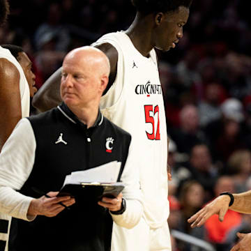 Cincinnati Bearcats head coach Wes Miller talks to Cincinnati Bearcats center Moustapha Thiam (52) in the second half of the NCAA basketball game against the Georgia State Panthers at Fifth Third Arena in Cincinnati on Nov. 7, 2025.