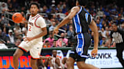 Feb 25, 2025; Coral Gables, Florida, USA;  Miami (Fl) Hurricanes forward Brandon Johnson (2) brings the ball up the court as Duke Blue Devils guard Caleb Foster (1) defends during the second half at Watsco Center. Mandatory Credit: Jim Rassol-Imagn Images