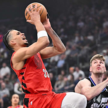 Apr 9, 2025; Salt Lake City, Utah, USA;  Portland Trail Blazers forward Toumani Camara (33) shoots over Utah Jazz center Kyle Filipowski (22) in the second half at Delta Center. Mandatory Credit: Jamie Sabau-Imagn Images