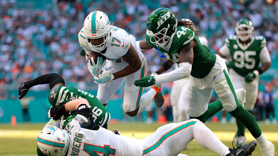 Miami Dolphins wide receiver Jaylen Waddle (17) dives over New York Jets safety Chuck Clark (36) after running with the football during the fourth quarter at Hard Rock Stadium.  | Sam Navarro-Imagn Images