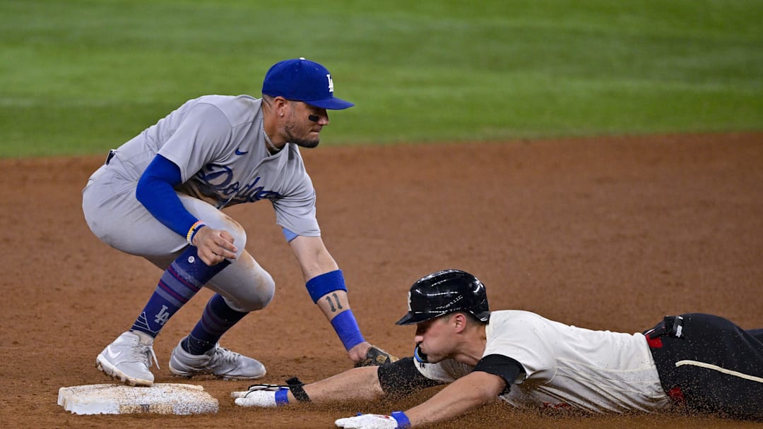 Jul 21, 2023; Arlington, Texas, USA; Los Angeles Dodgers shortstop Miguel Rojas (11) and Texas Rangers shortstop Corey Seager (5) in action during the game between the Texas Rangers and the Los Angeles Dodgers at Globe Life Field. Mandatory Credit: Jerome Miron-Imagn Images