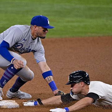 Jul 21, 2023; Arlington, Texas, USA; Los Angeles Dodgers shortstop Miguel Rojas (11) and Texas Rangers shortstop Corey Seager (5) in action during the game between the Texas Rangers and the Los Angeles Dodgers at Globe Life Field. Mandatory Credit: Jerome Miron-Imagn Images