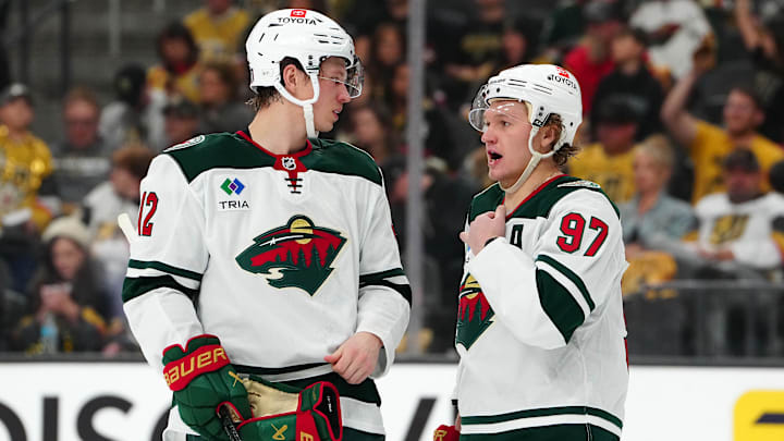 Apr 22, 2025; Las Vegas, Nevada, USA; Minnesota Wild left wing Matt Boldy (12) talks to Minnesota Wild left wing Kirill Kaprizov (97) before a face off against the Vegas Golden Knights during the second period of game two of the first round of the 2025 Stanley Cup Playoffs at T-Mobile Arena. Mandatory Credit: Stephen R. Sylvanie-Imagn Images