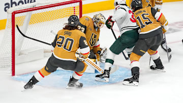 Apr 20, 2025; Las Vegas, Nevada, USA; Vegas Golden Knights goaltender Adin Hill (33) makes a save as Minnesota Wild right wing Ryan Hartman (38) looks for a rebound during the third period of game one of the first round of the 2025 Stanley Cup Playoffs at T-Mobile Arena. Mandatory Credit: Stephen R. Sylvanie-Imagn Images