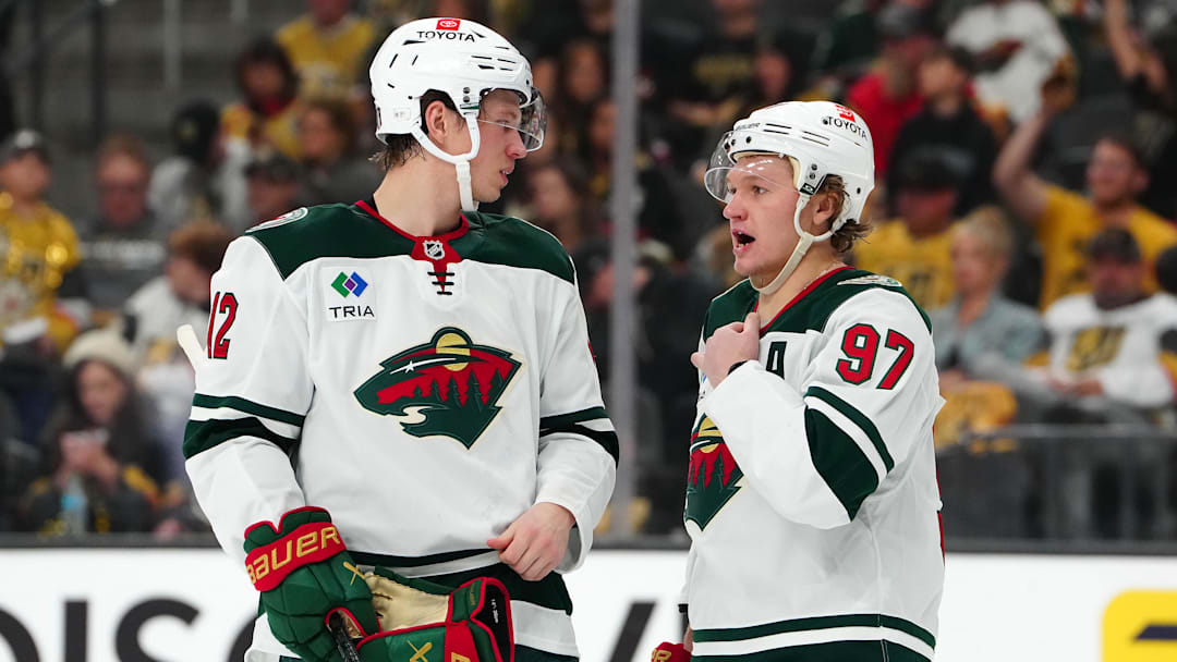 Apr 22, 2025; Las Vegas, Nevada, USA; Minnesota Wild left wing Matt Boldy (12) talks to Minnesota Wild left wing Kirill Kaprizov (97) before a face off against the Vegas Golden Knights during the second period of game two of the first round of the 2025 Stanley Cup Playoffs at T-Mobile Arena. Mandatory Credit: Stephen R. Sylvanie-Imagn Images