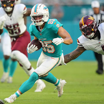 Miami Dolphins wide receiver River Cracraft (85) runs against Washington Commanders linebacker Frankie Luvu (4)  during the first quarter at Hard Rock Stadium. 
