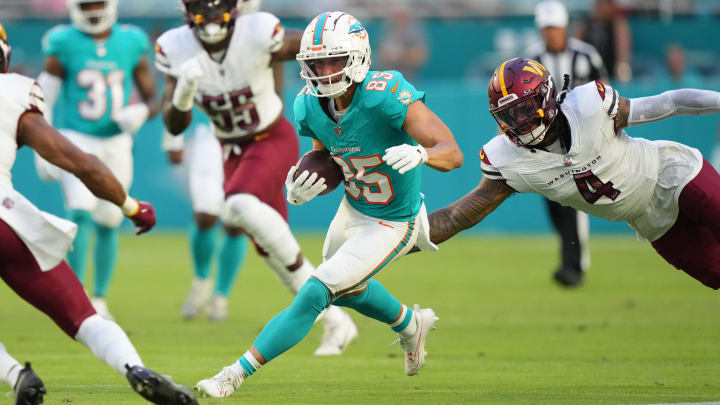 Miami Dolphins wide receiver River Cracraft (85) runs against Washington Commanders linebacker Frankie Luvu (4)  during the first quarter at Hard Rock Stadium on Saturday.