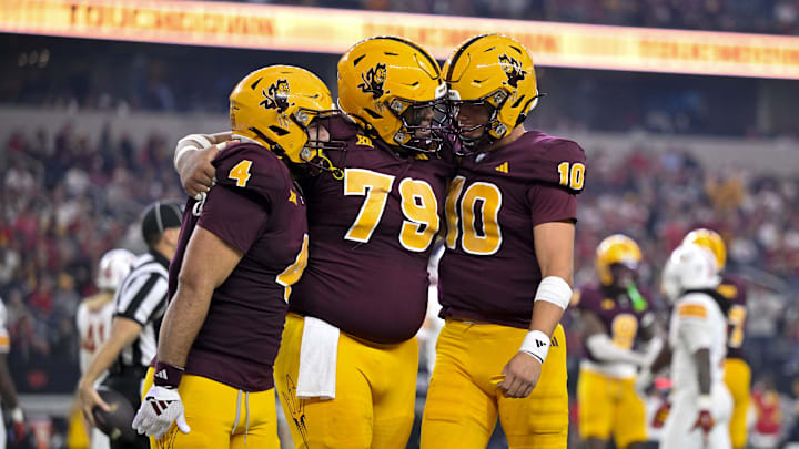 Dec 7, 2024; Arlington, TX, USA; Arizona State Sun Devils running back Cam Skattebo (4) and offensive lineman Leif Fautanu (79) and quarterback Sam Leavitt (10) celebrate during the game between the Iowa State Cyclones and the Arizona State Sun Devils at AT&T Stadium. Mandatory Credit: Jerome Miron-Imagn Images