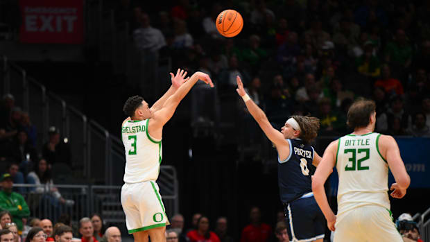 Oregon Ducks guard Jackson Shelstad (3) shoots the ball against Liberty Flames guard Colin Porter (0) during the first half