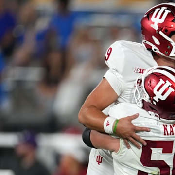 Indiana Hoosiers quarterback Kurtis Rourke (9) and offensive lineman Mike Katic (56) celebrate after a touchdown against UCLA at the Rose Bowl.