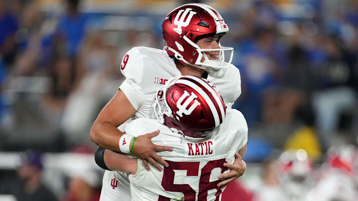 Indiana Hoosiers quarterback Kurtis Rourke (9) and offensive lineman Mike Katic (56) celebrate after a touchdown against UCLA at the Rose Bowl.