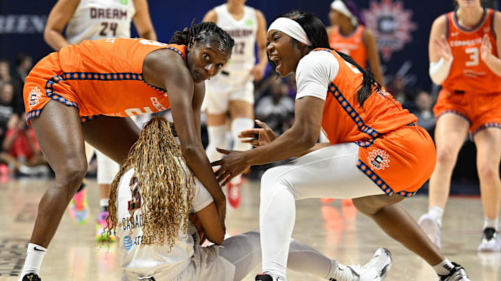 Connecticut Sun forward Aneesah Morrow (24) reacts after battling Atlanta Dream guard Jordin Canada (3) for the ball with guard Mamignan Toure (28) during the second half at Mohegan Sun Arena. 