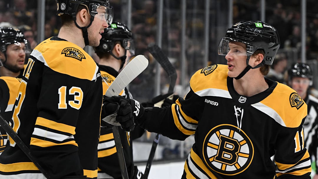 Jan 14, 2025; Boston, Massachusetts, USA; Boston Bruins center Trent Frederic (11) celebrates with center Charlie Coyle (13) after scoring a goal against the Tampa Bay Lightning during the first period at the TD Garden. Mandatory Credit: Brian Fluharty-Imagn Images
