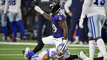 Aug 16, 2025; Arlington, Texas, USA; Baltimore Ravens linebacker Jay Higgins IV (49) sacks Dallas Cowboys quarterback Will Grier (15) during the second half at AT&T Stadium. Mandatory Credit: Jerome Miron-Imagn Images