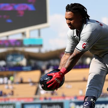 Sep 8, 2024; Los Angeles, California, USA;  Cleveland Guardians designated hitter Jose Ramirez (11) catches a helmet after grounded into a double play during the ninth inning against the Los Angeles Dodgers at Dodger Stadium. Mandatory Credit: Kiyoshi Mio-Imagn Images