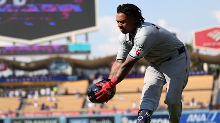 Sep 8, 2024; Los Angeles, California, USA;  Cleveland Guardians designated hitter Jose Ramirez (11) catches a helmet after grounded into a double play during the ninth inning against the Los Angeles Dodgers at Dodger Stadium. Mandatory Credit: Kiyoshi Mio-Imagn Images