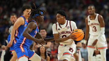 Apr 5, 2025; San Antonio, TX, USA; Auburn Tigers guard Tahaad Pettiford (0) controls the ball against Florida Gatorsguard Denzel Aberdeen (11) during the second half in the semifinals of the men's Final Four of the 2025 NCAA Tournament at the Alamodome. Mandatory Credit: Bob Donnan-Imagn Images