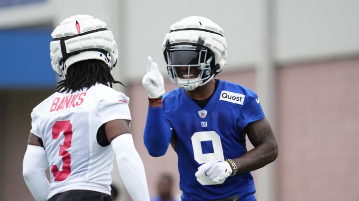 Jul 25, 2024; East Rutherford, NY, USA; New York Giants wide receiver Malik Nabers (9) and cornerback Deonte Banks (3) react after a drill during training camp at Quest Diagnostics Training Center.  