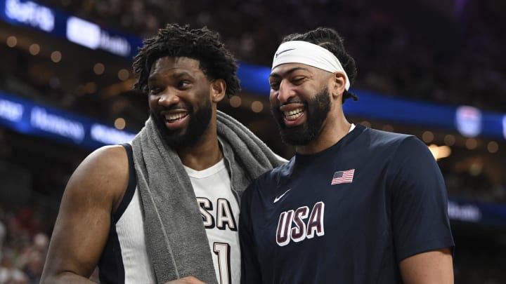 Jul 10, 2024; Las Vegas, Nevada, USA; USA forward Joel Embiid (11) and forward Anthony Davis (14) laugh together on the bench during the fourth quarter against Canada in the USA Basketball Showcase at T-Mobile Arena. Mandatory Credit: Candice Ward-USA TODAY Sports