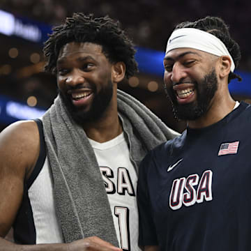 Jul 10, 2024; Las Vegas, Nevada, USA; USA forward Joel Embiid (11) and forward Anthony Davis (14) laugh together on the bench during the fourth quarter against Canada in the USA Basketball Showcase at T-Mobile Arena. Mandatory Credit: Candice Ward-Imagn Images