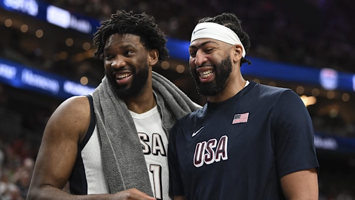 Jul 10, 2024; Las Vegas, Nevada, USA; USA forward Joel Embiid (11) and forward Anthony Davis (14) laugh together on the bench during the fourth quarter against Canada in the USA Basketball Showcase at T-Mobile Arena. Mandatory Credit: Candice Ward-Imagn Images