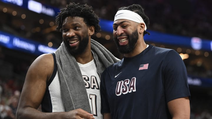 Jul 10, 2024; Las Vegas, Nevada, USA; USA forward Joel Embiid (11) and forward Anthony Davis (14) laugh together on the bench during the fourth quarter against Canada in the USA Basketball Showcase at T-Mobile Arena. Mandatory Credit: Candice Ward-USA TODAY Sports