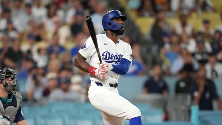 Aug 20, 2024; Los Angeles, California, USA;  Los Angeles Dodgers right fielder Jason Heyward (23) hits a three-run home run in the eighth inning as Seattle Mariners catcher Cal Raleigh (29) watches at Dodger Stadium. Mandatory Credit: Kirby Lee-USA TODAY Sports