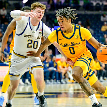 Mar 8, 2025; South Bend, Indiana, USA; Cal Bears guard Jeremiah Wilkinson (0) drives to the basket as Notre Dame Fighting Irish guard J.R. Konieczny (20) defends in the first half at the Purcell Pavilion. Mandatory Credit: Matt Cashore-Imagn Images