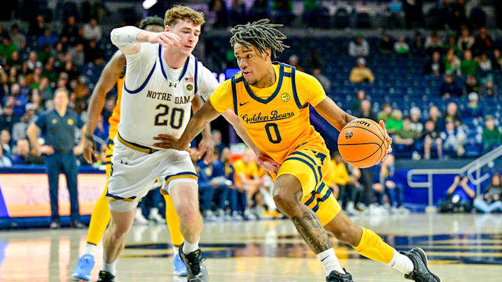 Mar 8, 2025; South Bend, Indiana, USA; Cal Bears guard Jeremiah Wilkinson (0) drives to the basket as Notre Dame Fighting Irish guard J.R. Konieczny (20) defends in the first half at the Purcell Pavilion. Mandatory Credit: Matt Cashore-Imagn Images