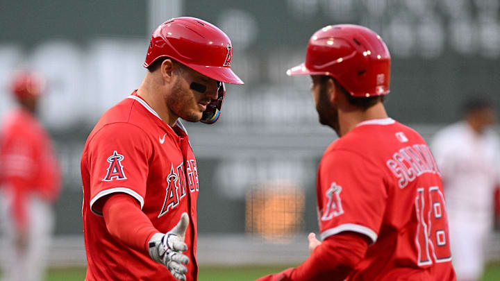 Los Angeles Angels first baseman Nolan Schanuel high-fives outfielder Mike Trout after scoring a run against the Boston Red Sox.