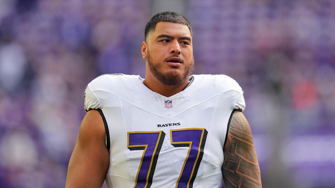 Nov 9, 2025; Minneapolis, Minnesota, USA; Baltimore Ravens guard Daniel Faalele (77) warms up before the game against the Minnesota Vikings at U.S. Bank Stadium. Mandatory Credit: Brad Rempel-Imagn Images