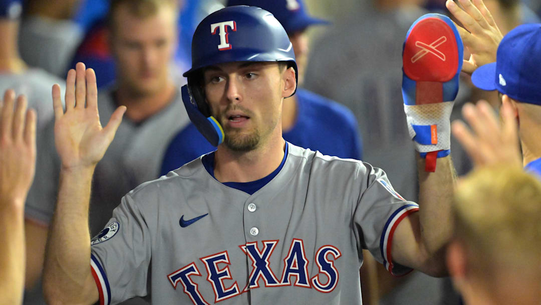Jul 28, 2025; Anaheim, California, USA; Texas Rangers center fielder Evan Carter (32) in the dugout after scoring a  run in the eighth inning against the Los Angeles Angels at Angel Stadium.