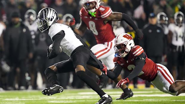 Nov 16, 2024; Madison, Wisconsin, USA;  Wisconsin Badgers cornerback Ricardo Hallman (2) grabs the jersey of Oregon Ducks wid