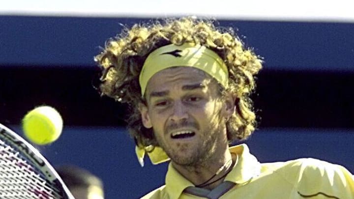 Gustavo Kuerten hits a shot at the French Open