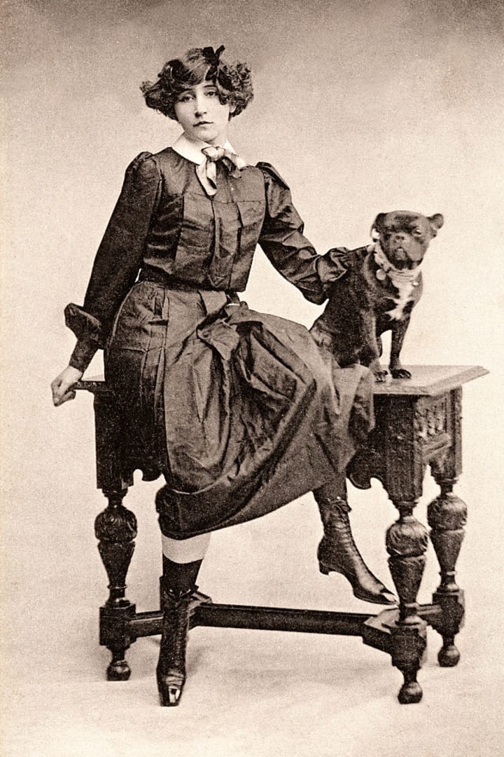 French writer Sidonie Gabrielle Colette with a French bulldog, circa 1900.