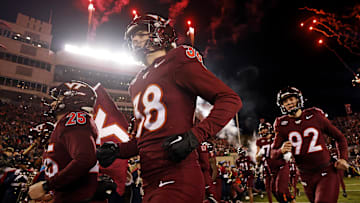 Nov 30, 2024; Blacksburg, Virginia, USA; The Virginia Tech Hokies runs onto the field during “Enter Sandman” before playing against the Virginia Cavaliers at Lane Stadium. Mandatory Credit: Peter Casey-Imagn Images