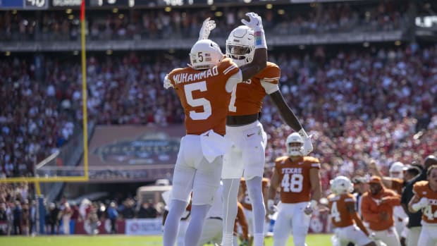 Texas Longhorns defensive players celebrate a play during a college football game in the SEC.