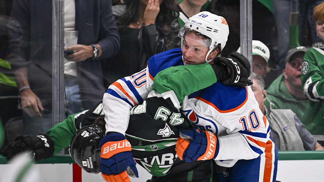 Mar 12, 2026; Dallas, Texas, USA; Dallas Stars center Justin Hryckowian (49) fights with Edmonton Oilers center Trent Frederic (10) during the third period at the American Airlines Center. Mandatory Credit: Jerome Miron-Imagn Images