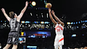 Apr 6, 2025; Brooklyn, New York, USA; Toronto Raptors guard Ochai Agbaji (30) shoots a three point jump shot over Brooklyn Nets forward Drew Timme (26) during the first half at Barclays Center. Mandatory Credit: Gregory Fisher-Imagn Images