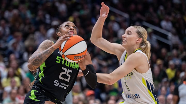 Seattle Storm guard Tiffany Mitchell shoots the ball against Dallas Wings guard Paige Bueckers.
