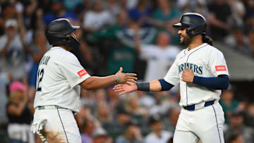 Aug 5, 2025; Seattle, Washington, USA; Seattle Mariners first baseman Josh Naylor (12) and third baseman Eugenio Suarez (28) celebrate after both scored a run against the Chicago White Sox during the sixth inning at T-Mobile Park. Mandatory Credit: Steven Bisig-Imagn Images