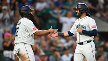 Aug 5, 2025; Seattle, Washington, USA; Seattle Mariners first baseman Josh Naylor (12) and third baseman Eugenio Suarez (28) celebrate after both scored a run against the Chicago White Sox during the sixth inning at T-Mobile Park. Mandatory Credit: Steven Bisig-Imagn Images