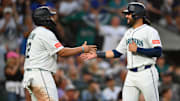 Aug 5, 2025; Seattle, Washington, USA; Seattle Mariners first baseman Josh Naylor (12) and third baseman Eugenio Suarez (28) celebrate after both scored a run against the Chicago White Sox during the sixth inning at T-Mobile Park. Mandatory Credit: Steven Bisig-Imagn Images