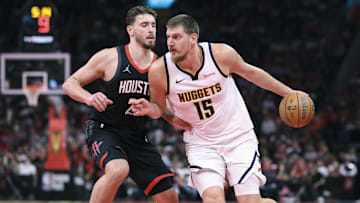 Nov 21, 2025; Houston, Texas, USA; Denver Nuggets center Nikola Jokic (15) controls the ball as Houston Rockets center Alperen Sengun (28) defends during the fourth quarter at Toyota Center. Mandatory Credit: Troy Taormina-Imagn Images