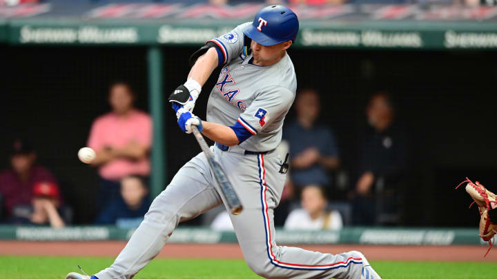 Aug 23, 2024; Cleveland, Ohio, USA; Texas Rangers shortstop Corey Seager (5) hits an RBI double during the second inning against the Cleveland Guardians at Progressive Field. 