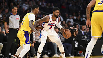 Nov 8, 2024; Los Angeles, California, USA; Philadelphia 76ers forward Paul George (8) dribbles against Los Angeles Lakers forward Cam Reddish (5) during the first half at Crypto.com Arena. Mandatory Credit: Jonathan Hui-Imagn Images